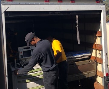 nurses unloading medical beds